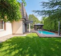 A family house in Ivanka pri Dunaji with a swimming pool and a gazebo amidst greenery.