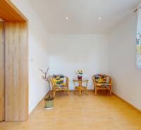 The interior of a family house with rattan furniture and a wooden decor floor.