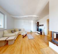 Living room in a family house with a fireplace and a wooden decor floor.