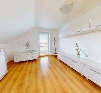 Interior of a family house with a wooden decor floor and white furniture.