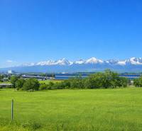 View of the snow-covered mountains from a family house in Poprad on Poprad Street.
