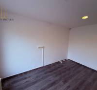 Commercial spaces with white walls and wood-patterned flooring.