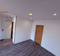 Interior of commercial spaces with white walls and a floor with a wooden decor.