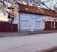 A building with commercial premises on Čapajevova Street in Prešov, with a renovated facade and roof.
