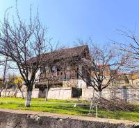 A cottage in Malé Krštenany with a garden and fruit trees during clear weather.