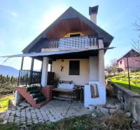 A cottage in Malé Kršteňany with a terrace, garden, and a view of the countryside.