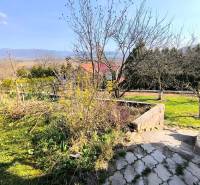 Garden view with fruit trees and mountains in the background in Partizánske near the cottage.