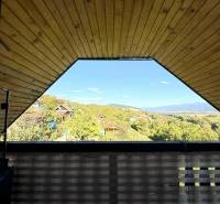 The view from the cottage of the surrounding green hills and houses in Partizánske.