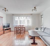 Living room in a 3-room apartment with a wooden decor floor and a sofa set.