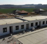 A family house in Klasov with a flat roof and parking space, surrounded by countryside.