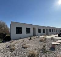 A low-rise family house in Klasov with a gravel yard and a parking space.