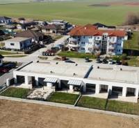 Aerial view of residential buildings and greenery in Klasov, with family houses in the suburbs.