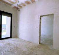The interior of a family house with large sliding doors and a view of the garden.