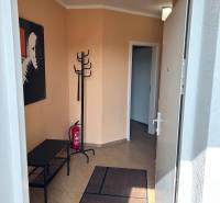 A hallway with a coat rack and a floor with a wooden decor in a 3-room apartment.
