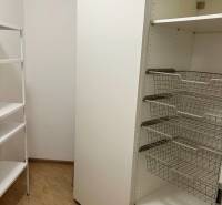 Storage space with shelves and wire baskets in a 3-room apartment.