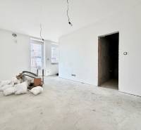 The interior of a spacious, bright studio apartment in the process of renovation.