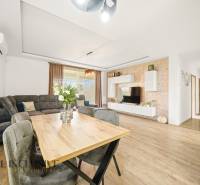 Living room in a family house with a wood-patterned floor and a comfortable sofa.