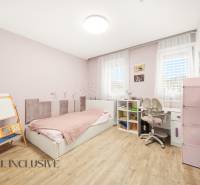 Children's room in a family house with wooden decor, furniture, toys, and a bed.