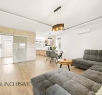 Living room in a family house with a large sofa and a wooden decor floor.