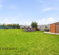 A garden of a family house in Dunajská Streda with a lawn, a gazebo, and a swimming pool.