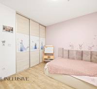 Children's room with cartoon motifs in a family house, floor with wooden decor.