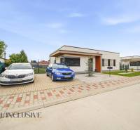A family house in Dunajská Streda with parking spaces and a fenced garden.