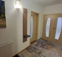 Entrance hallway in a 2-room apartment with carpet decor and a painting on the wall.