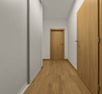 A hallway in a 2-room apartment with a wooden decor floor and wooden doors.