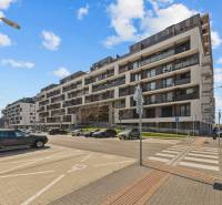 Zuzana Chalupová Street in Bratislava - Petržalka with housing estate architecture and a parking lot.