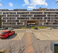 Apartment building near Zuzany Chalupovej Street, Bratislava - Petržalka, with parking in front of the building.