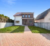 A family house in Vojka nad Dunajom with brick cladding and a garden.