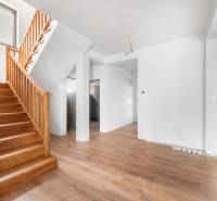 Interior of a family house with stairs and a wooden decor floor.