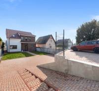A family house in Vojka nad Dunajom with a landscaped yard, parking space, and lawn.