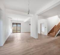 Interior of a family house with an open space and staircase, floor with wood decor.