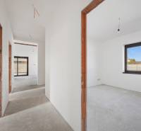 The interior of a family house with unfinished doors, large windows, and the layout of the rooms.