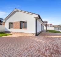 A family house in Vojka nad Dunajom with a brick facade and a paved courtyard.
