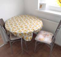 Dining nook with a table and two chairs in a studio apartment.
