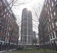 A high-rise building among brick buildings on Čulenova Street in Bratislava - Staré Mesto.