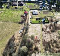 Land - housing in Vydrná with a view of family houses and greenery.