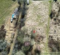 Plots - living in Vydrná with nature and cars parked on grassy terrain.