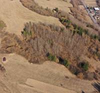Agricultural and forest lands near Námestovo, mixed growths, and a river in the distance.