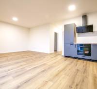 A kitchen in a family house with a kitchen unit and a floor with a wooden decor.