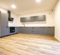 A kitchen unit in a family house with a wooden decor floor.