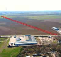 Agricultural and forest lands near Štúrovo, with an industrial building and fertile fields on the horizon.