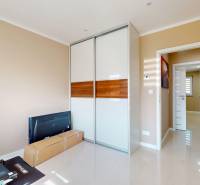 A room in a family house with a sliding wardrobe and a treadmill.