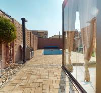 A swimming pool and terrace behind a family house on Maria Theresa Street in Holíč.