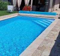 A swimming pool at a family house on Maria Theresa Street in Holíč, with a terrace and paving.