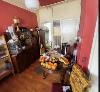 A family house with a wooden decor floor and fruit on the table in the interior.