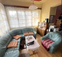 Living room in a family house with a curved sofa and a wooden decor floor.