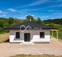 A family house in Harichovce with a simple roof surrounded by natural scenery.